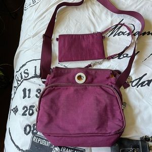 Baggallini purple raspberry travel bag with tons of zippered pockets and wallet.